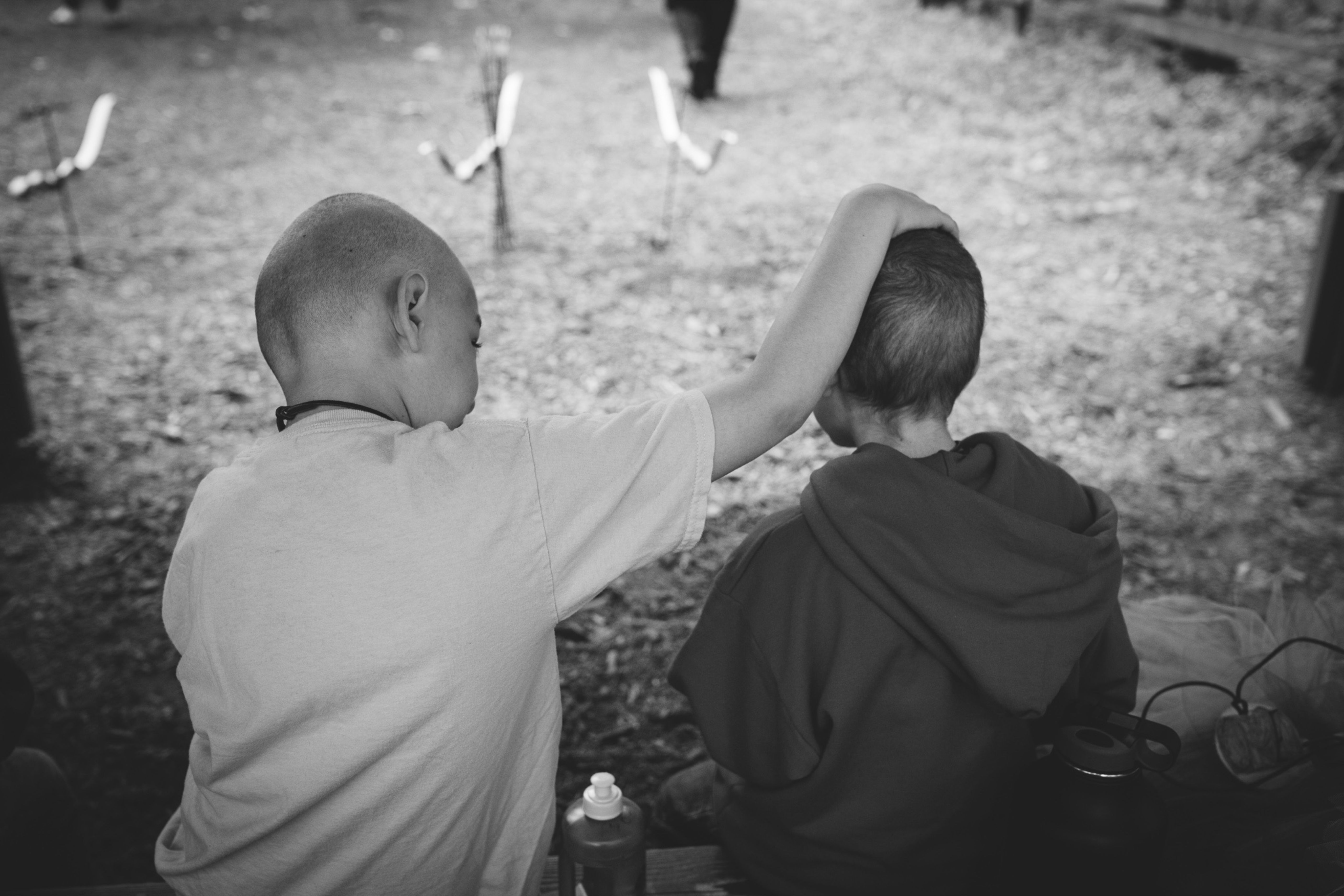 two kids with arm around each other 